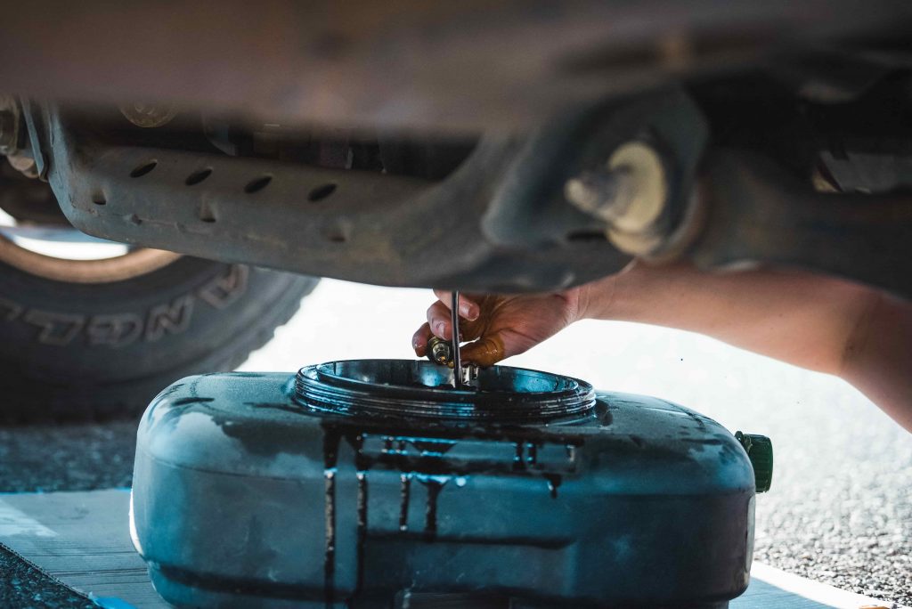 DIY car oil change, draining car oil.