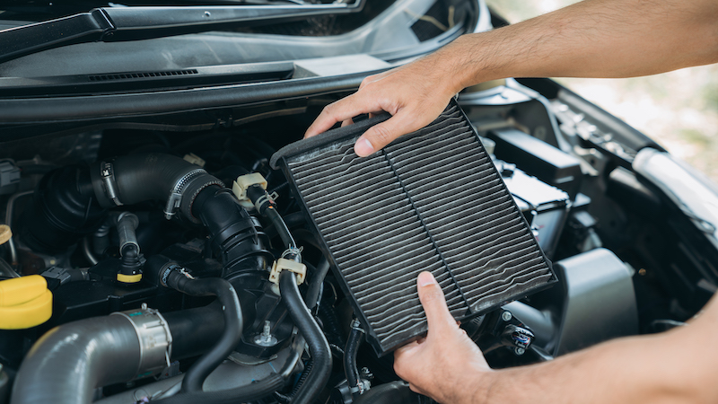 Car overheating causes, holding car air filter.
