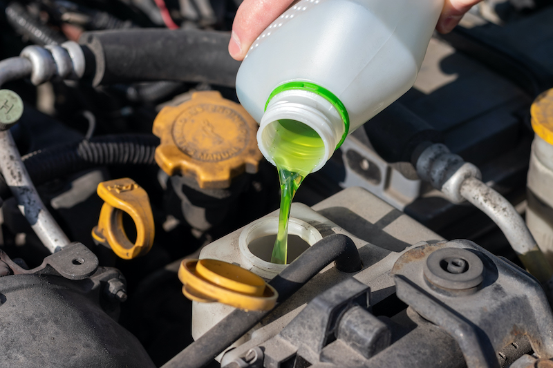 Summer car care tips, pouring car coolant.